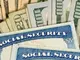 USA Social security cards laid on dollar bills